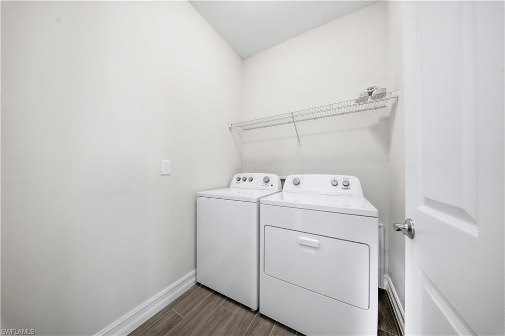 1059 Enbrook Loop Naples, FL 34114 - Photo 26 of 40 Laundry area with washer and dryer and wood finish floors