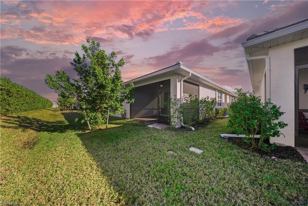 1059 Enbrook Loop Naples, FL 34114 - Photo 31 of 40 View of green lawn with a sunroom