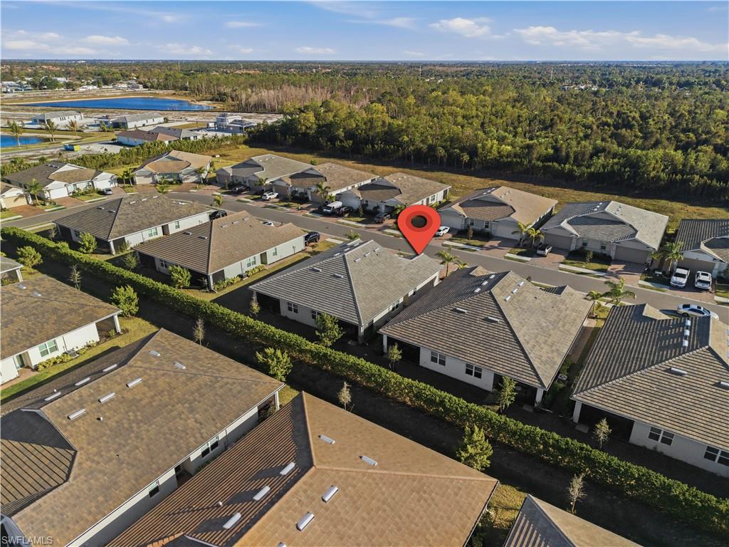 1059 Enbrook Loop Naples, FL 34114 - Photo 33 of 40 Aerial view of residential area with a forest and a large body of water