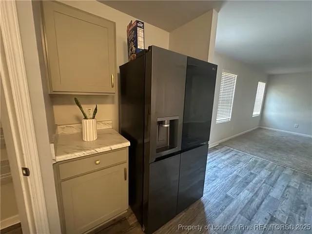 a kitchen with metallic refrigerator freezer and a dishwasher