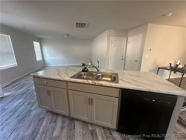 a bathroom with a granite countertop sink a toilet and mirror