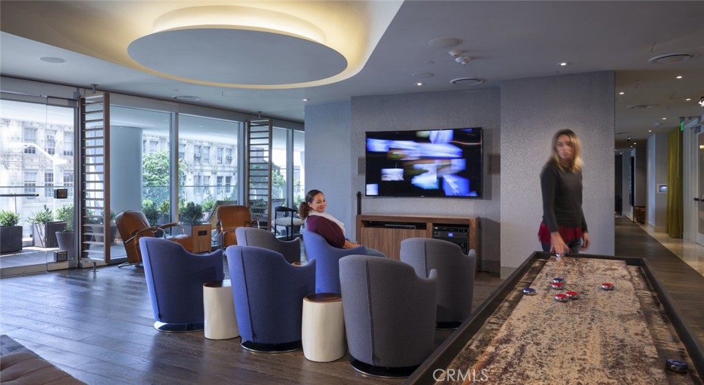 100 Van Ness Avenue, Unit 402 San Francisco, CA 94102 - Photo 16 of 75 a living room with furniture a rug and a flat screen tv