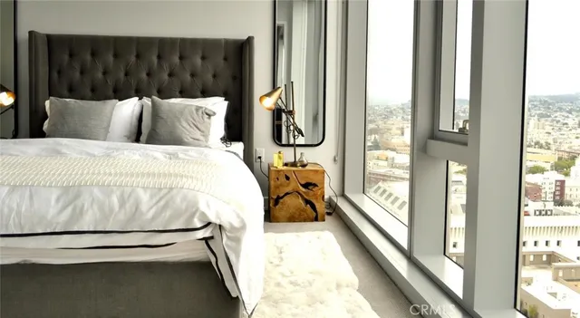 a bedroom with a bed and a large window