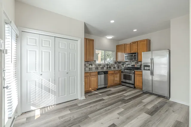 a kitchen with granite countertop cabinets and stainless steel appliances