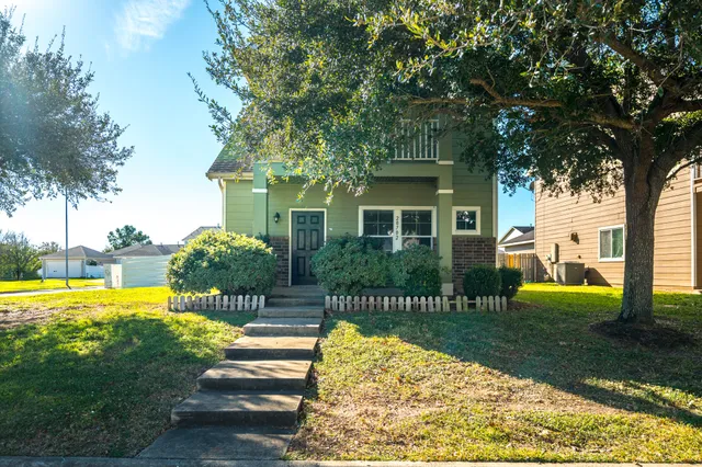 a view of a house with a yard patio and swimming pool