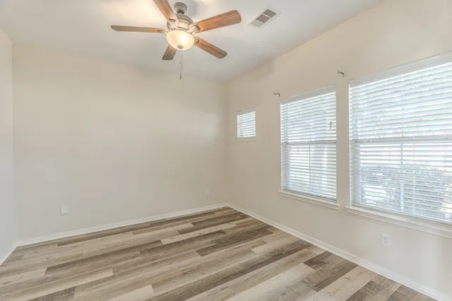 a view of empty room with ceiling fan