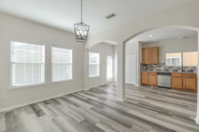 a view of a kitchen with a sink and cabinets