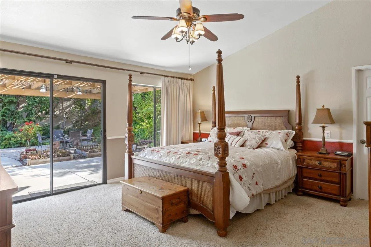 1787 Wolverine Way Vista, CA 92084 - Photo 18 of 35 a bed room with a bed and a chandelier