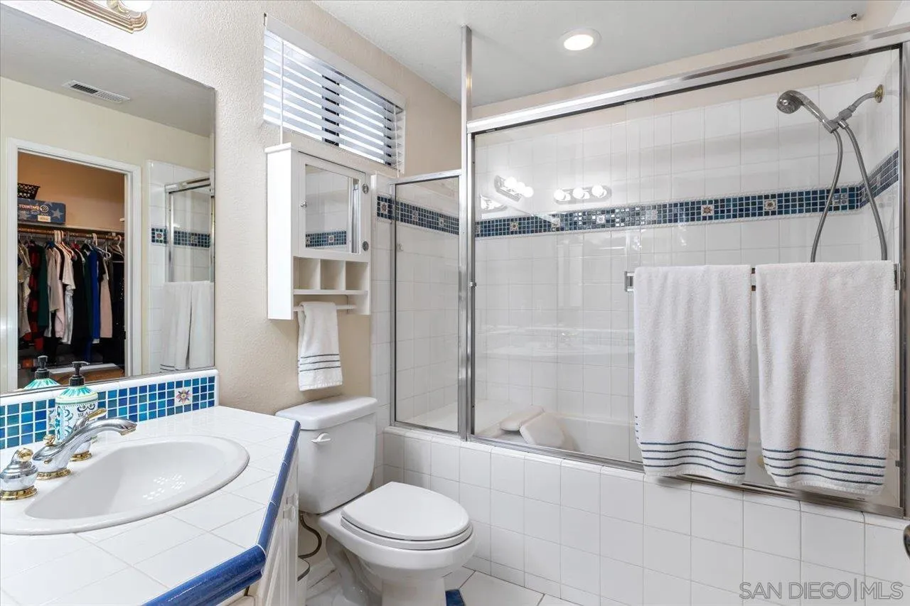1787 Wolverine Way Vista, CA 92084 - Photo 21 of 35 a bathroom with a sink a toilet and shower