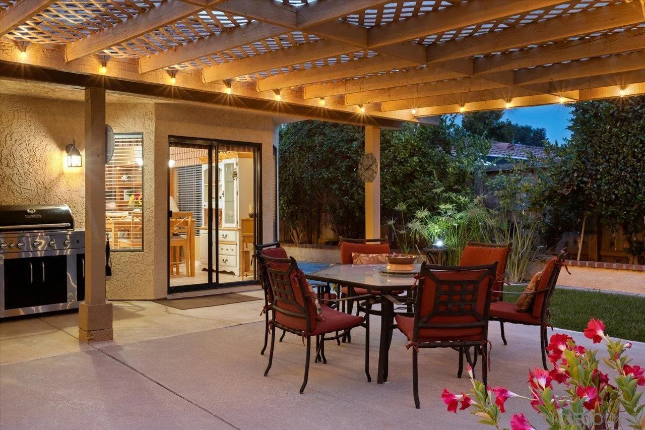 1787 Wolverine Way Vista, CA 92084 - Photo 31 of 35 a view of a patio with a dining table and chairs with wooden floor