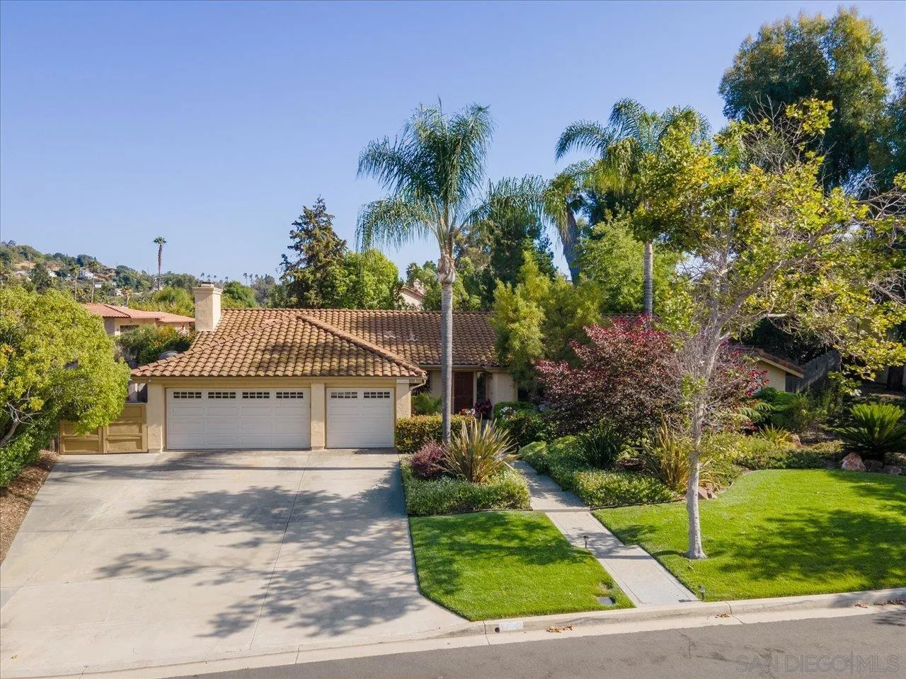 1787 Wolverine Way Vista, CA 92084 - Photo 7 of 35 a front view of a house with a garden