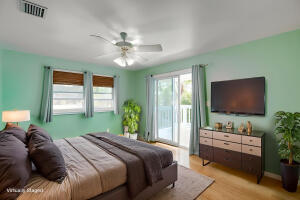 1006 16th Terrace Key West, FL 33040 - Photo 10 of 49 a bedroom with a bed and a flat screen tv
