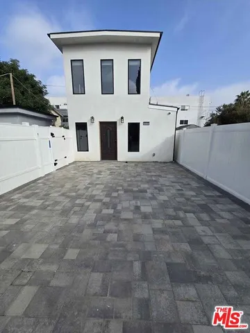 a view of white house with a garage