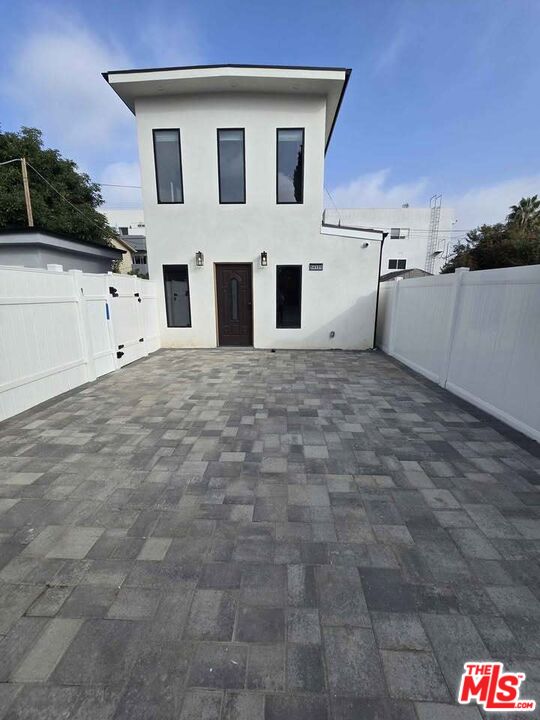 a view of white house with a garage