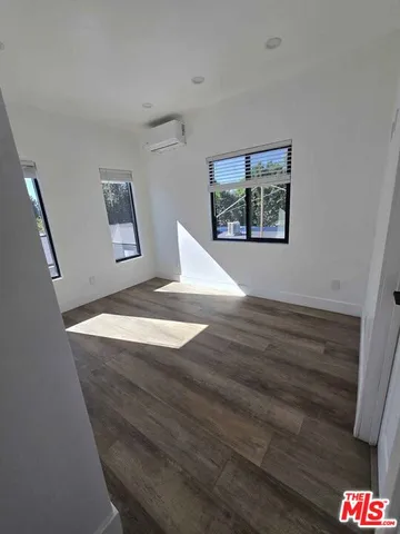 a view of a hallway view with wooden floor and staircase