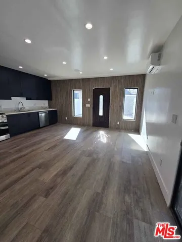 a kitchen with kitchen island stainless steel appliances a stove a sink and a refrigerator