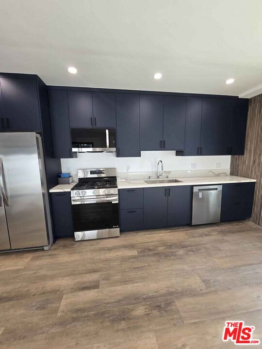 14121 Califa Street Sherman Oaks, CA 91401 - Photo 25 of 33 a kitchen with kitchen island stainless steel appliances a stove a sink and a refrigerator