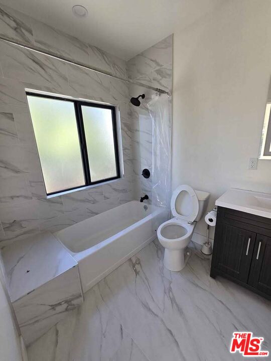 14121 Califa Street Sherman Oaks, CA 91401 - Photo 9 of 33 a bathroom with a granite countertop toilet a sink and a bathtub