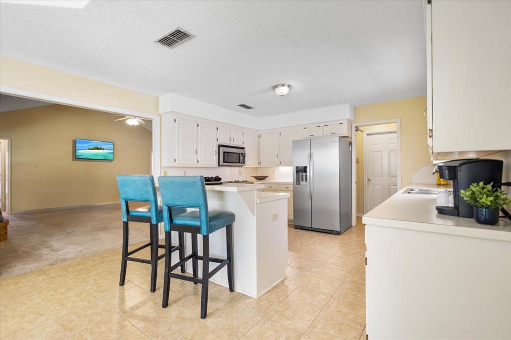 2824 Crestview Avenue Tyler, TX 75701 - Photo 16 of 39 a kitchen with refrigerator and chairs