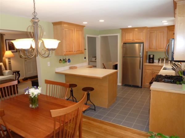 88 Hemlock Road Sudbury, MA 01776 - Photo 6 of 25 a kitchen with stainless steel appliances granite countertop a sink a stove a refrigerator a dining table and chairs