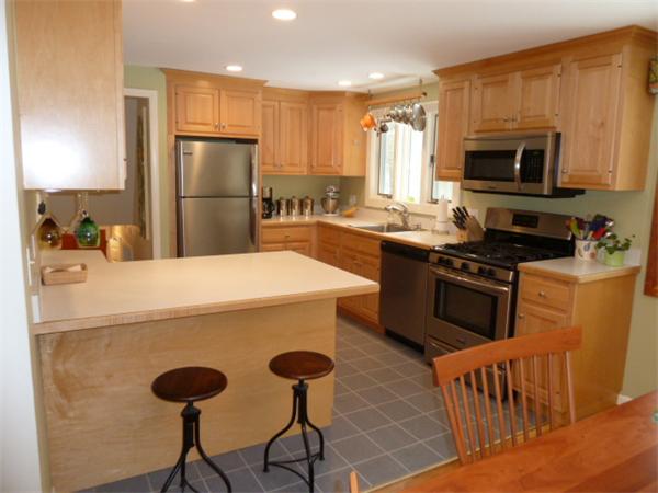 88 Hemlock Road Sudbury, MA 01776 - Photo 7 of 25 a kitchen with stainless steel appliances a stove a sink a microwave a refrigerator and cabinets