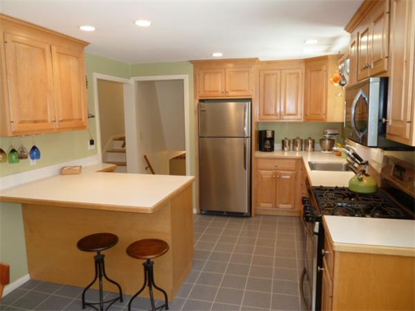 88 Hemlock Road Sudbury, MA 01776 - Photo 8 of 25 a kitchen with a refrigerator a sink and cabinets