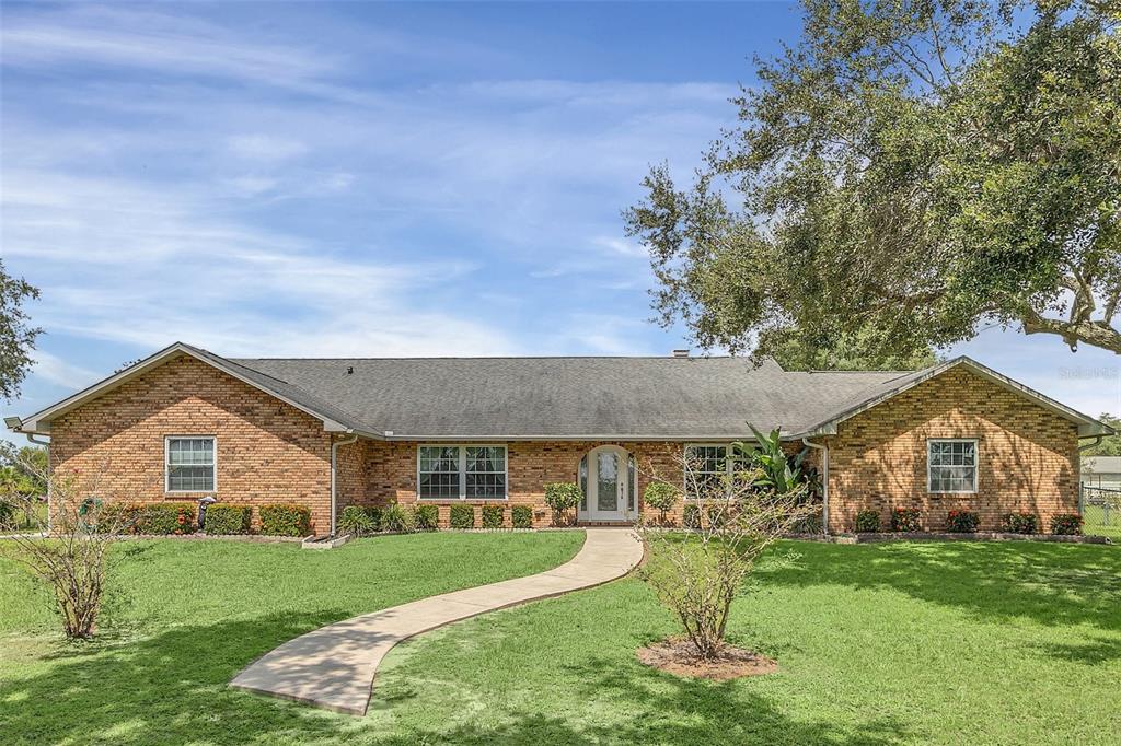 4147 Boggy Creek Road Kissimmee, FL 34744 - Photo 1 of 49 a front view of a house with a yard and porch