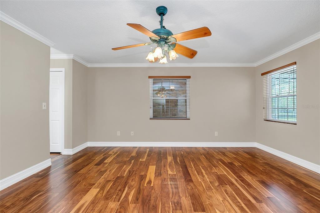 4147 Boggy Creek Road Kissimmee, FL 34744 - Photo 13 of 49 a view of an empty room with wooden floor and a window