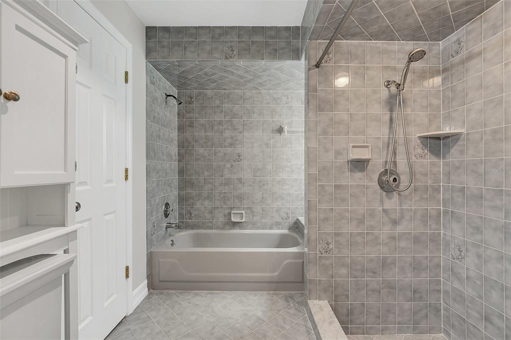 4147 Boggy Creek Road Kissimmee, FL 34744 - Photo 14 of 49 a spacious bathroom with a bathtub and a shower