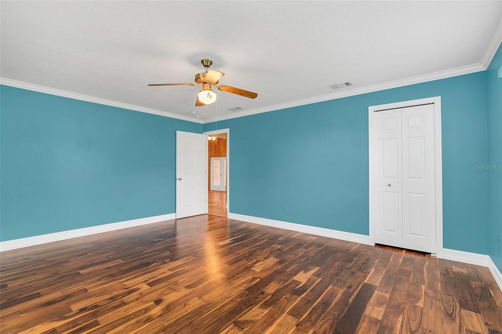 4147 Boggy Creek Road Kissimmee, FL 34744 - Photo 16 of 49 a view of an empty room with wooden floor and a window