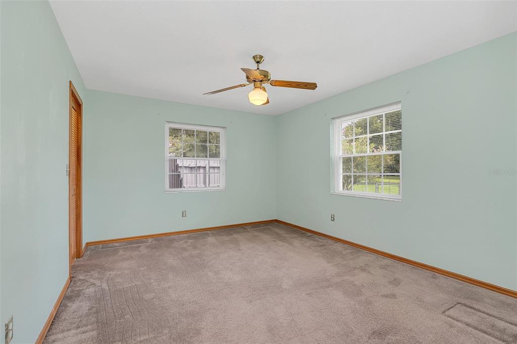 4147 Boggy Creek Road Kissimmee, FL 34744 - Photo 17 of 49 an empty room with windows and ceiling fan