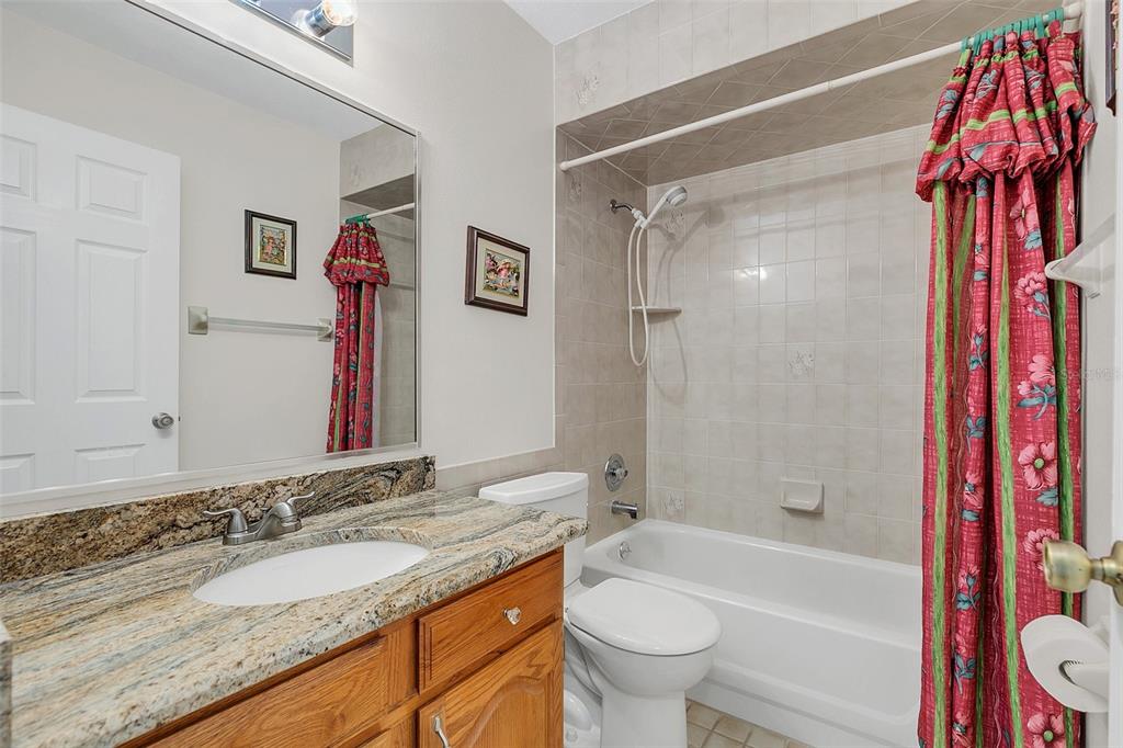 4147 Boggy Creek Road Kissimmee, FL 34744 - Photo 18 of 49 a bathroom with a granite countertop sink toilet and shower
