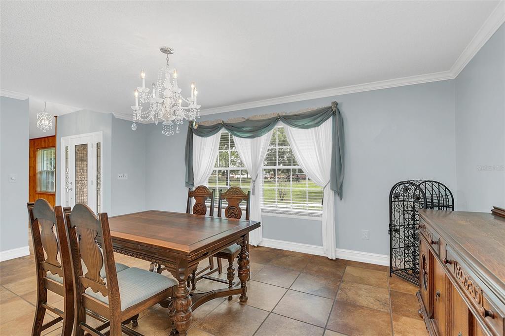 4147 Boggy Creek Road Kissimmee, FL 34744 - Photo 19 of 49 a view of a dining room with furniture and window