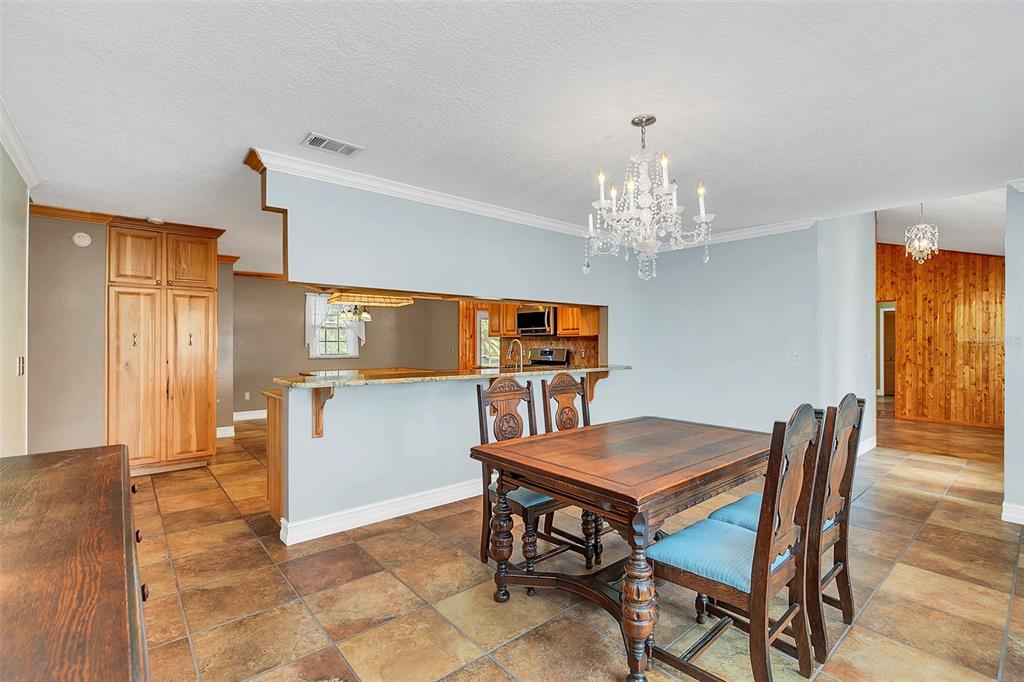 4147 Boggy Creek Road Kissimmee, FL 34744 - Photo 20 of 49 a view of a dining room with furniture and window