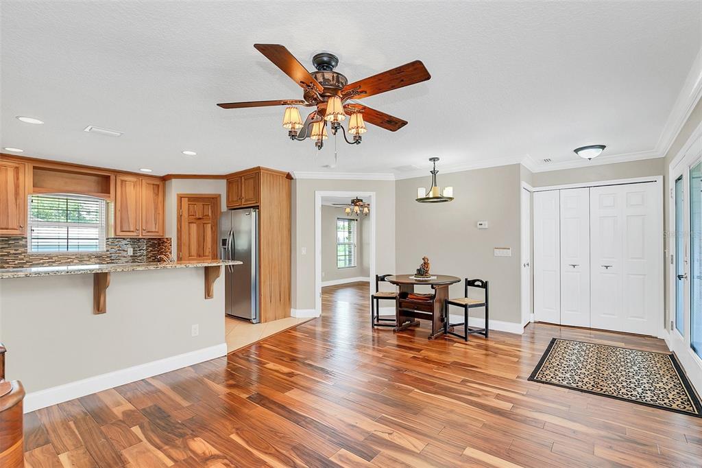 4147 Boggy Creek Road Kissimmee, FL 34744 - Photo 28 of 49 a view of a dining room with furniture window and wooden floor