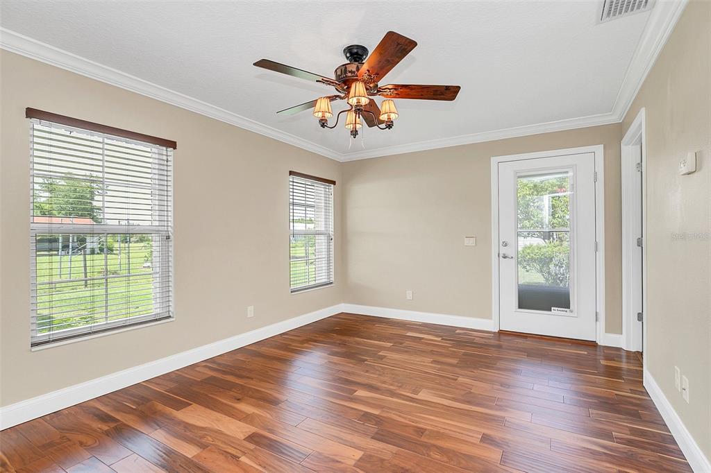 4147 Boggy Creek Road Kissimmee, FL 34744 - Photo 31 of 49 a view of an empty room with wooden floor and a window