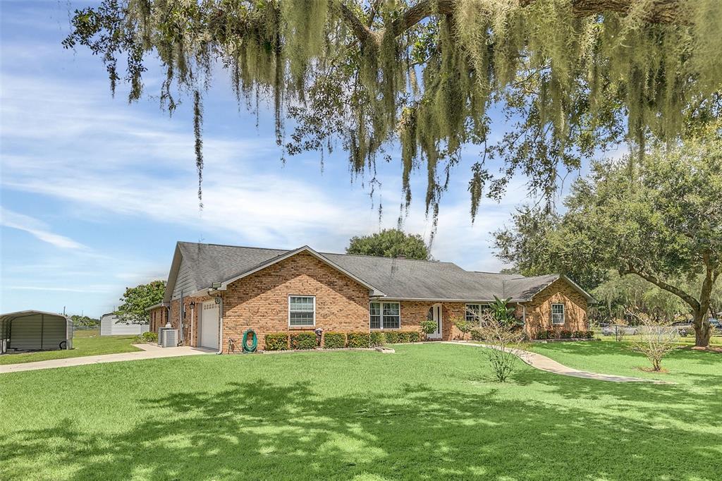 4147 Boggy Creek Road Kissimmee, FL 34744 - Photo 41 of 49 a view of a big house with a big yard and potted plants
