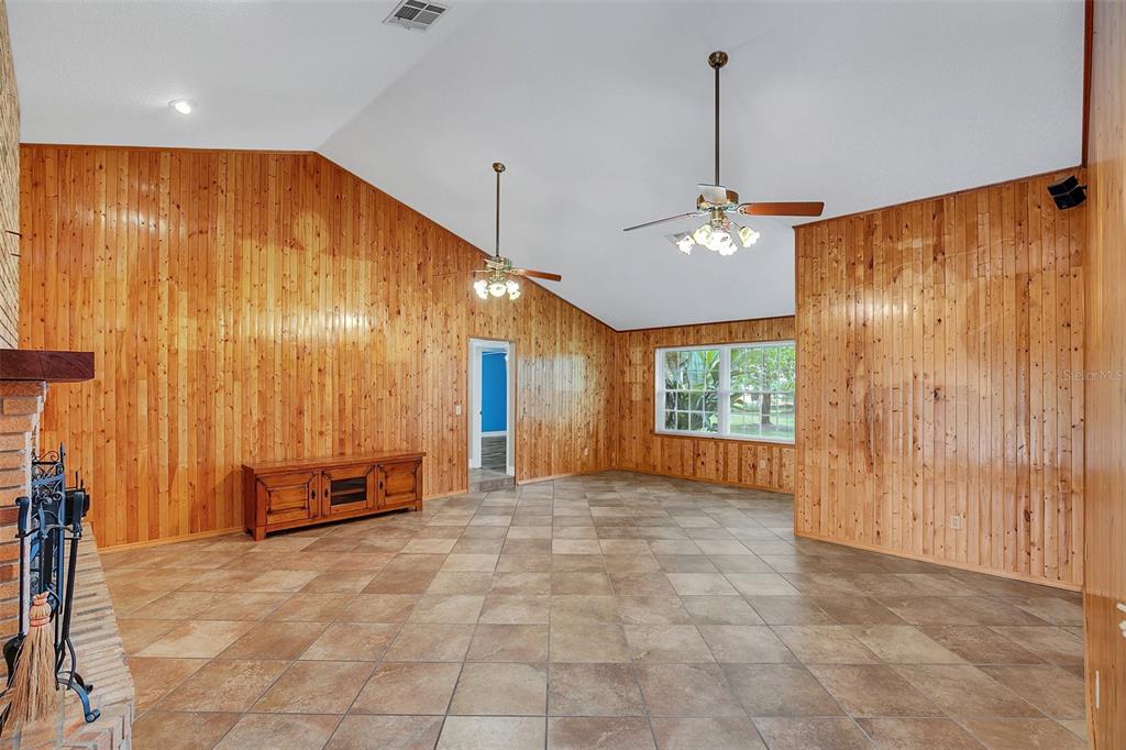 4147 Boggy Creek Road Kissimmee, FL 34744 - Photo 7 of 49 a view of a room with a chandelier fan and a window