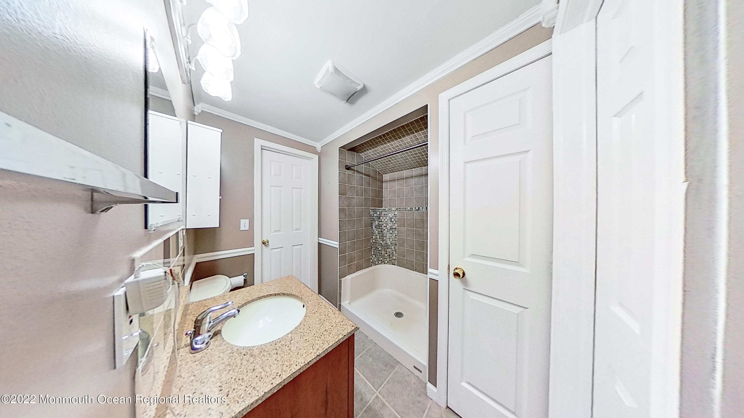 35 Oak Terrace Howell, NJ 07731 - Photo 23 of 27 a bathroom with a granite countertop sink and a mirror
