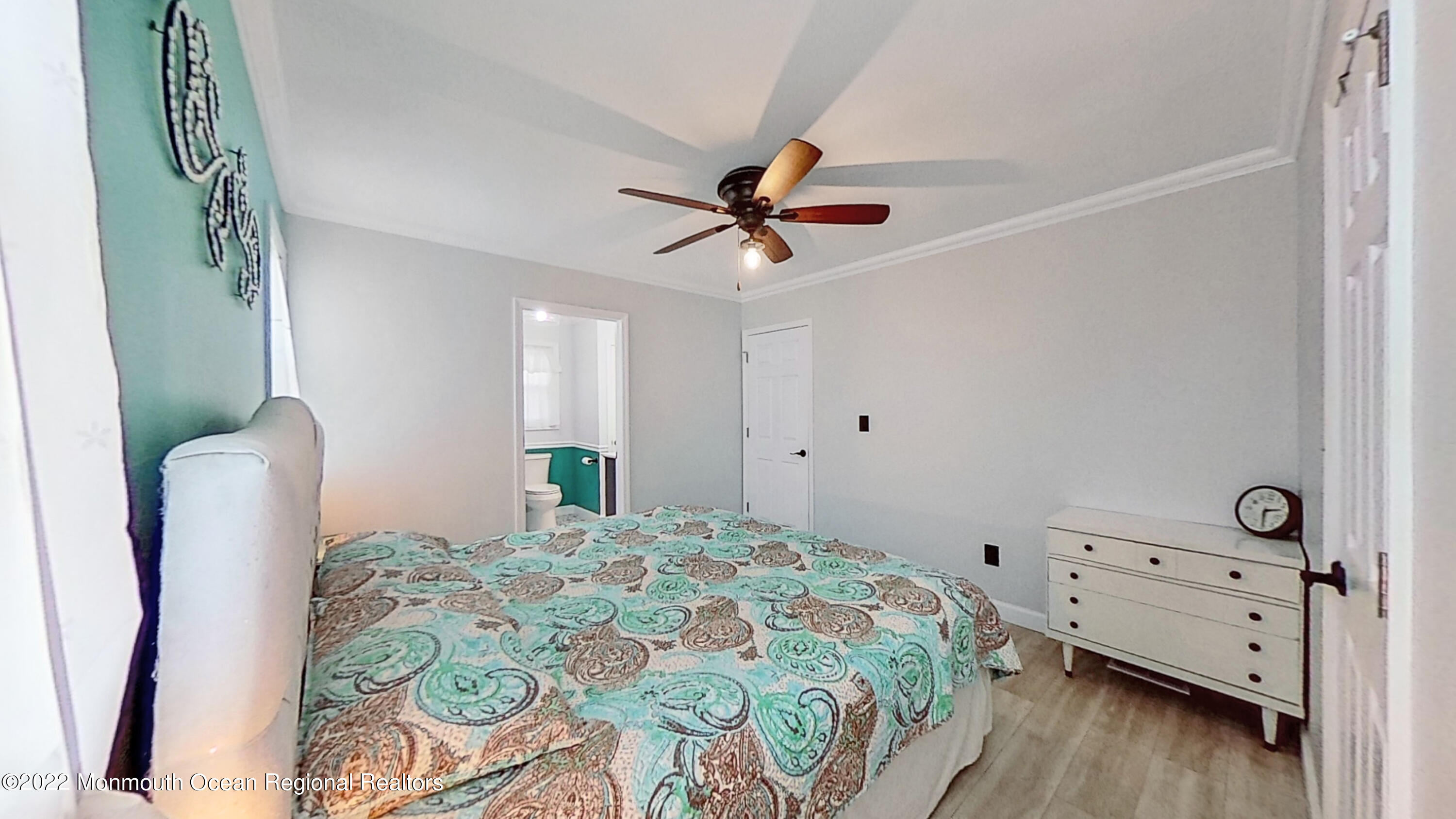 35 Oak Terrace Howell, NJ 07731 - Photo 8 of 27 a bedroom with a bed and a chandelier