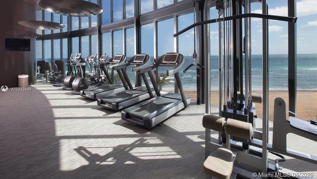 a bed sitting in a room next to a bathroom
