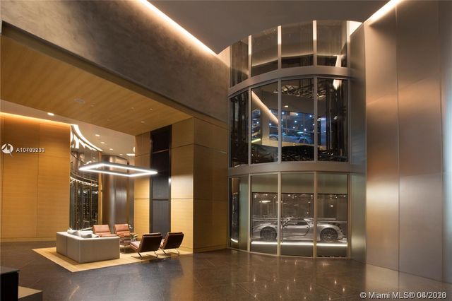 a room with pool table and a chandelier