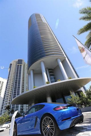 a living room with fireplace furniture and a large window