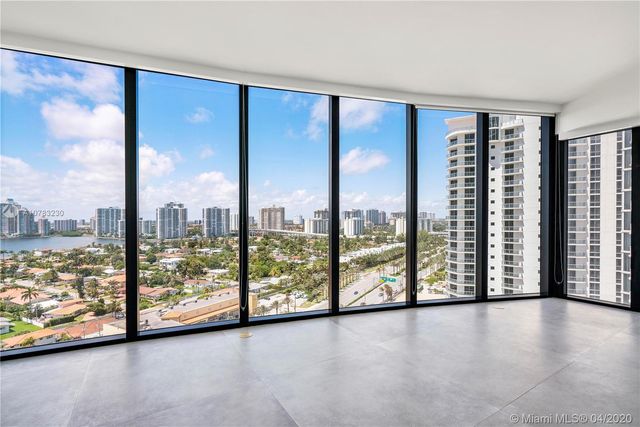 a view of empty room with furniture and a kitchen