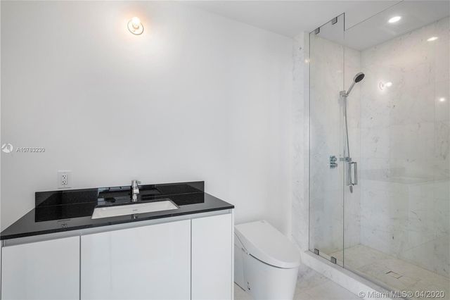 wooden floor chandelier and windows in an empty room