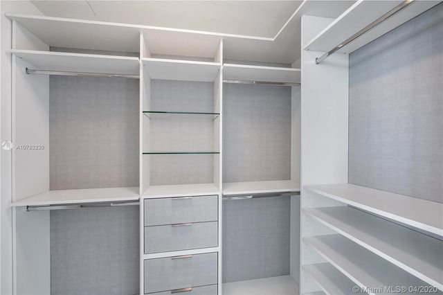 a dining room with kitchen island furniture a chandelier and kitchen view