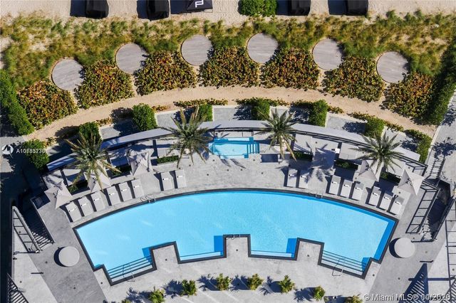 a bedroom with bed and a car parked