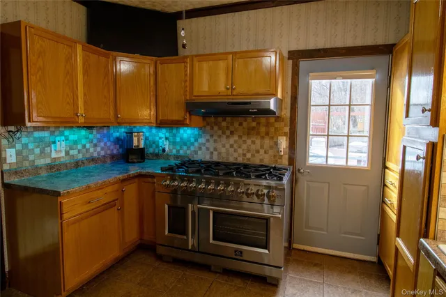 a kitchen with stainless steel appliances granite countertop a stove and a microwave