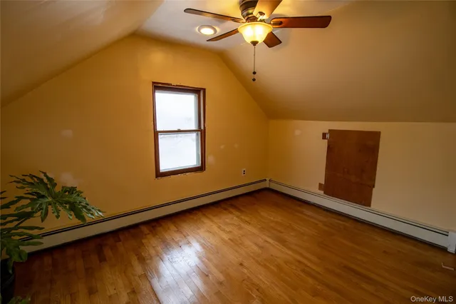 a view of a room with wooden floor and a window
