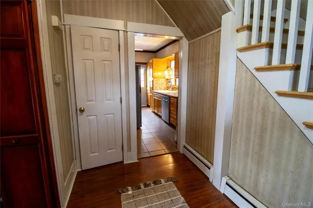 a view of hallway with wooden floor